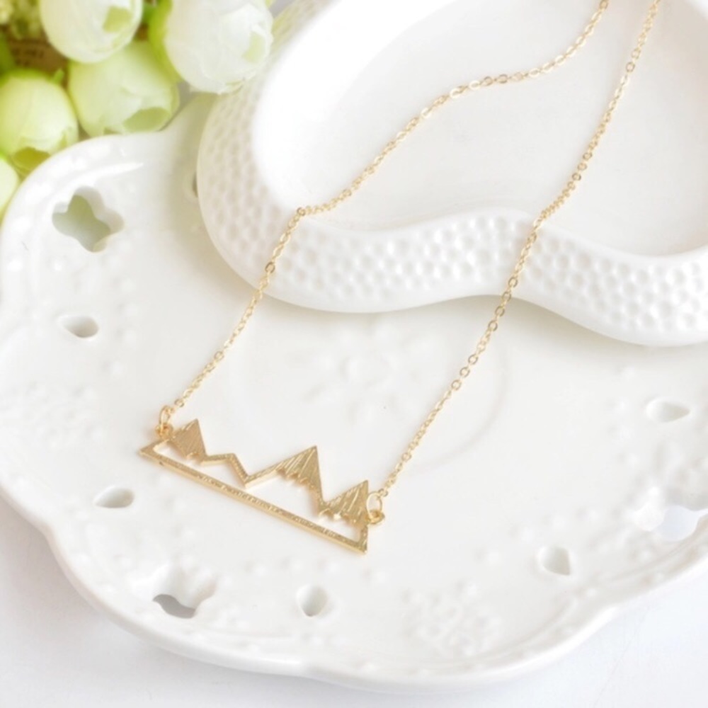 Gold colored mountain range necklace